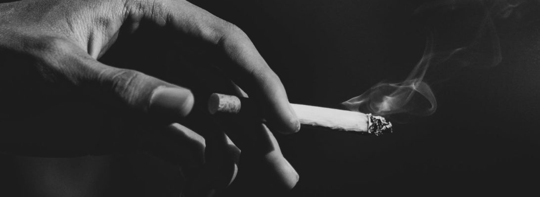 A smoker's hand holding a cigarette