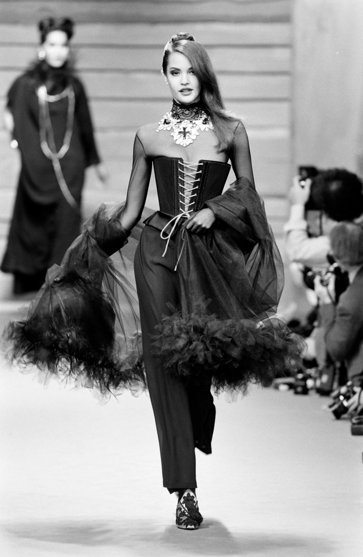 A 1980s female model on the catwalk wears an outfit by Christian Lacroix - for an article by Alex Noel, writer and digital marketer.