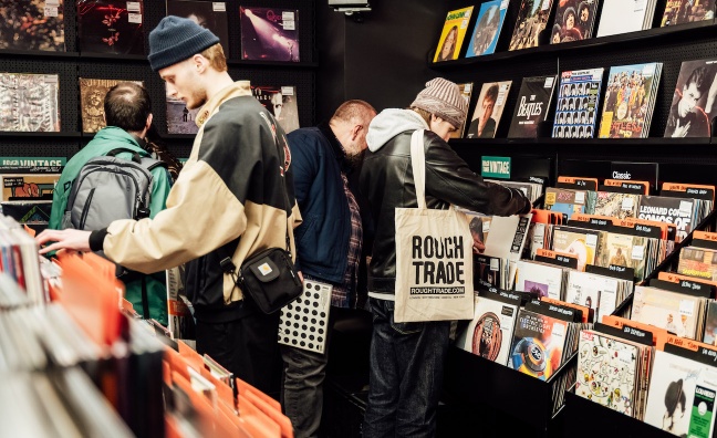 The interior of Rough Trade record shop, with music on vinyl and music fans browsing.
